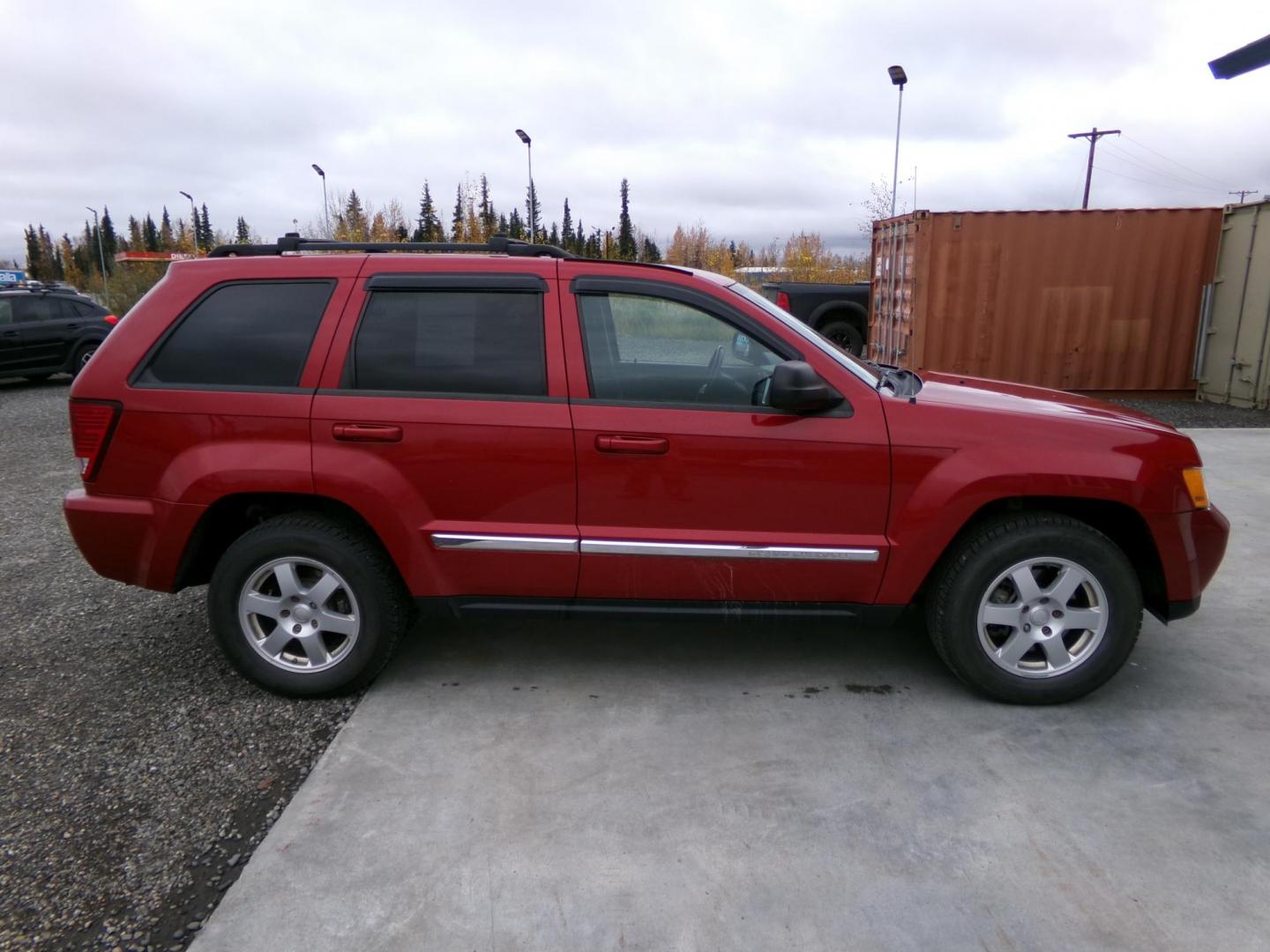 2010 Red Jeep Grand Cherokee Laredo 4WD (1J4PR4GK1AC) with an 3.7L V6 SOHC 12V engine, 5-Speed Automatic transmission, located at 2630 Philips Field Rd., Fairbanks, AK, 99709, (907) 458-0593, 64.848068, -147.780609 - Photo#2