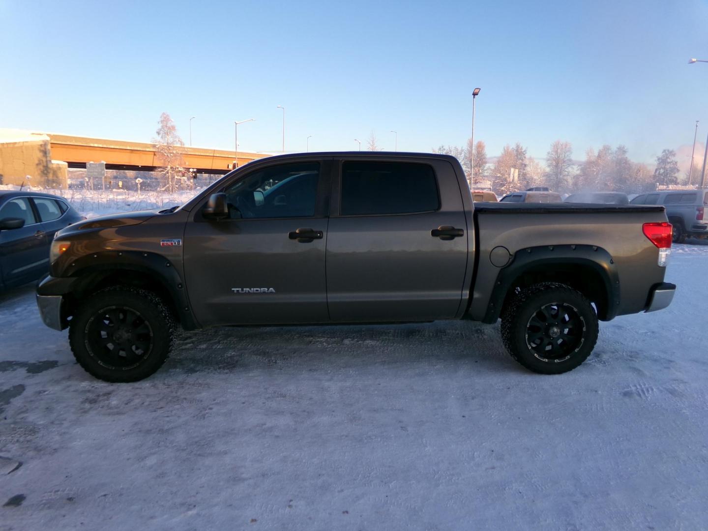 2013 Tan Toyota Tundra Tundra-Grade CrewMax 5.7L FFV 4WD (5TFDW5F18DX) with an 5.7L V8 DOHC 32V FFV engine, 6-Speed Automatic Overdrive transmission, located at 2630 Philips Field Rd., Fairbanks, AK, 99709, (907) 458-0593, 64.848068, -147.780609 - Photo#1